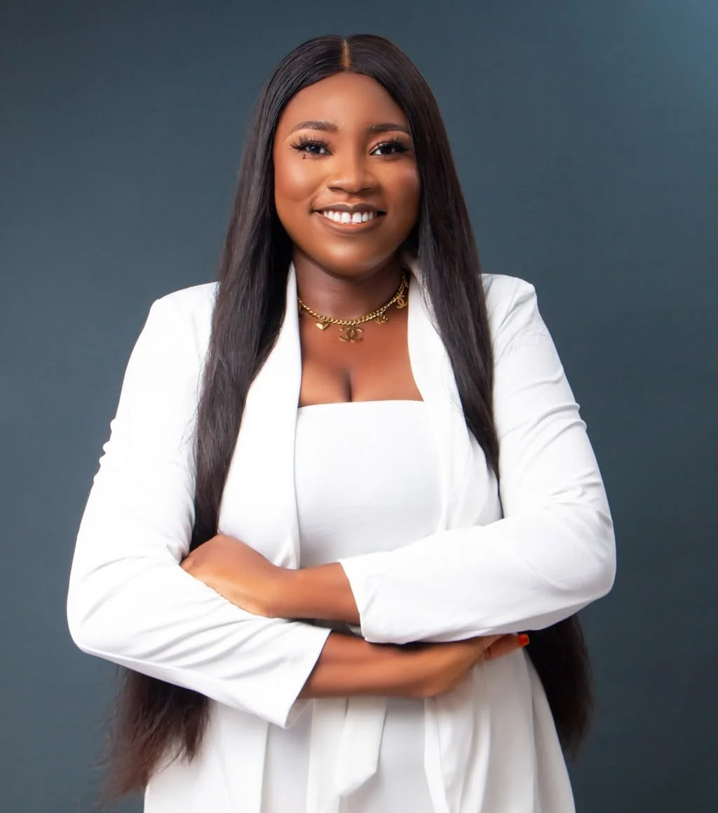 Victory Omoyine Smith Esq, host of the Legacy Wealth Academy community, smiling with arms folded
